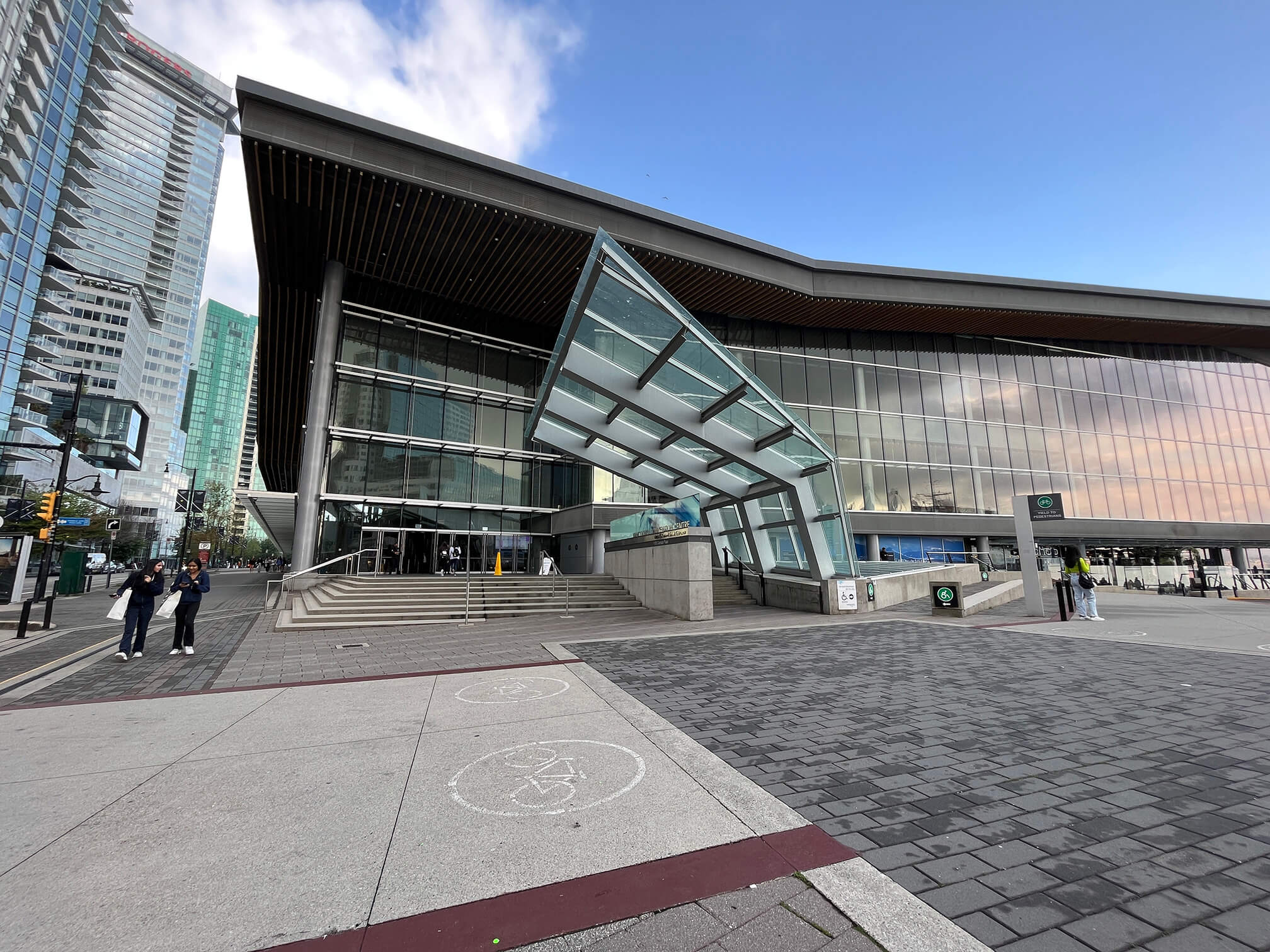Image of the main entrance of Vancouver Convention Centre West, with the stairs leading to the entrance and adjacent ramp.