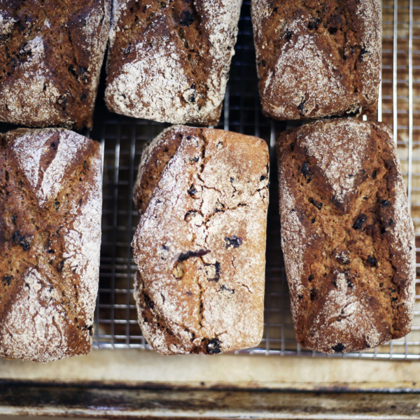 Freshly baked loaves of bread on a cooling rack