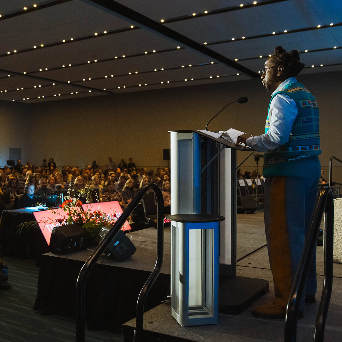 A speaker speaking to an audience at the 2024 Champions Retreat