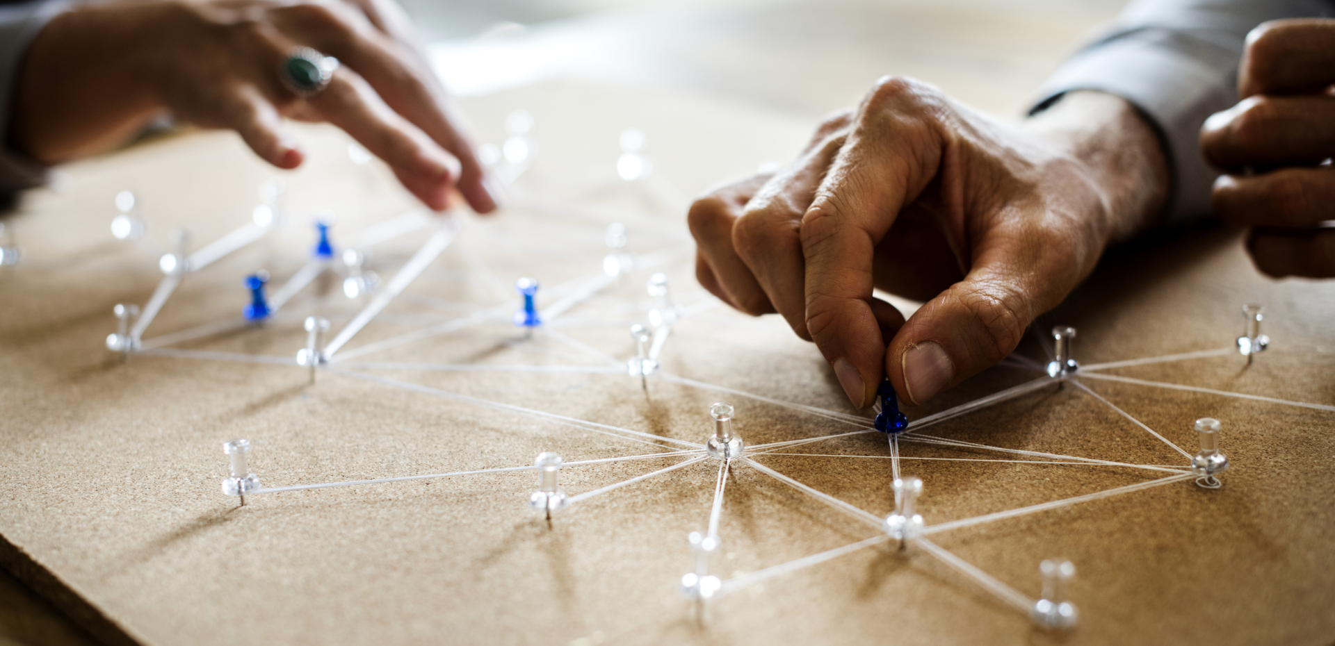 String connected by tacks on a board depicts a network.