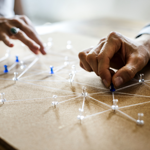 String connected by tacks on a board depicts a network.